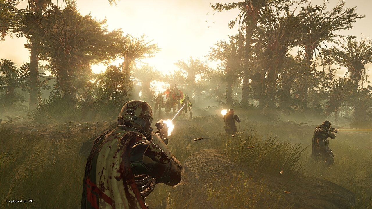 Helldivers advancing through a misty jungle under fire