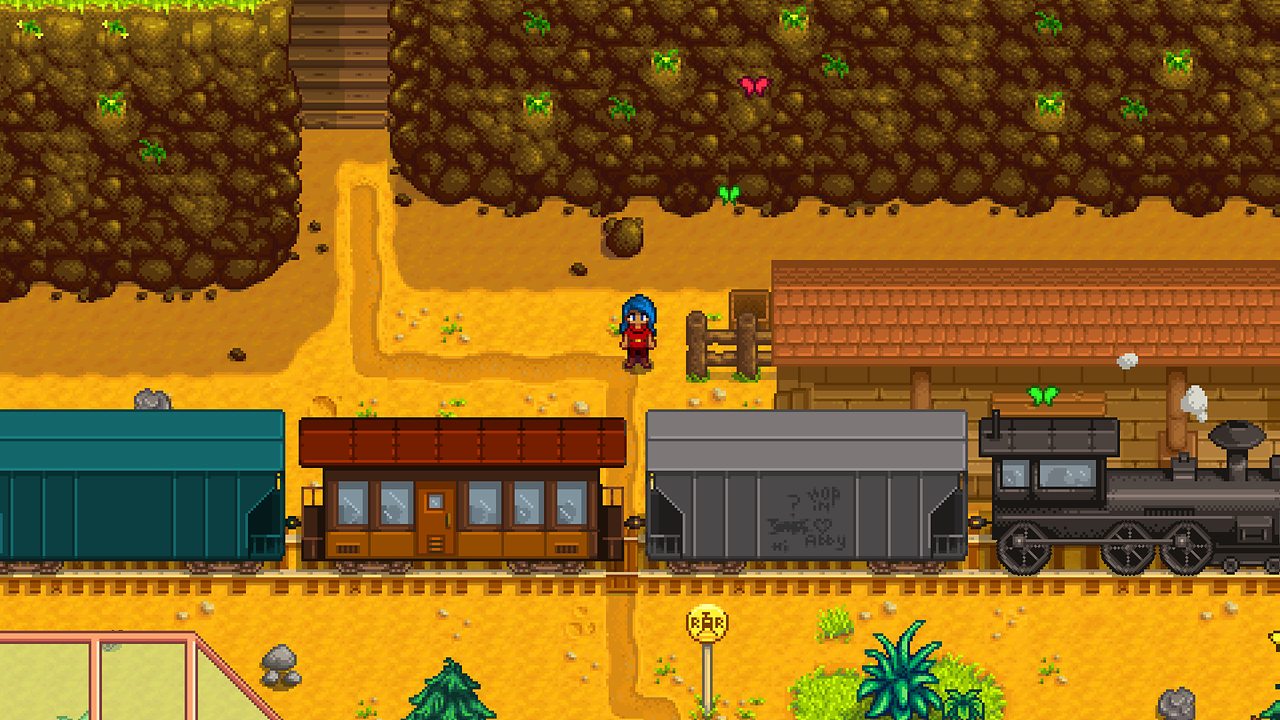 A train passing the station below a mine in autumn
